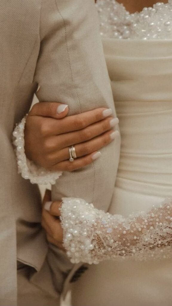 wedding style image of a bride holding her husbands arm